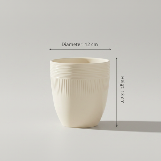 Single ivory ribbed ceramic pot on a tabletop