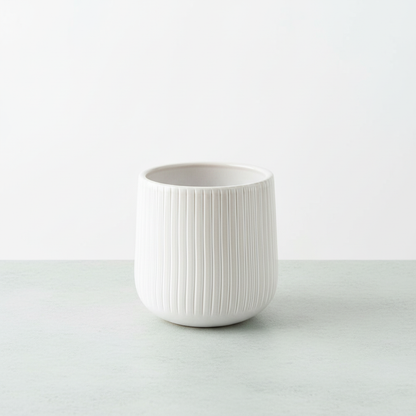 Bright HD white ribbed ceramic planter on tabletop
