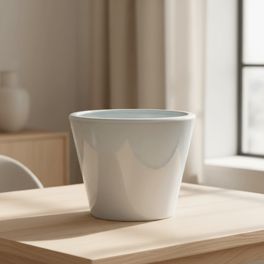Glossy white ceramic planter on a tabletop